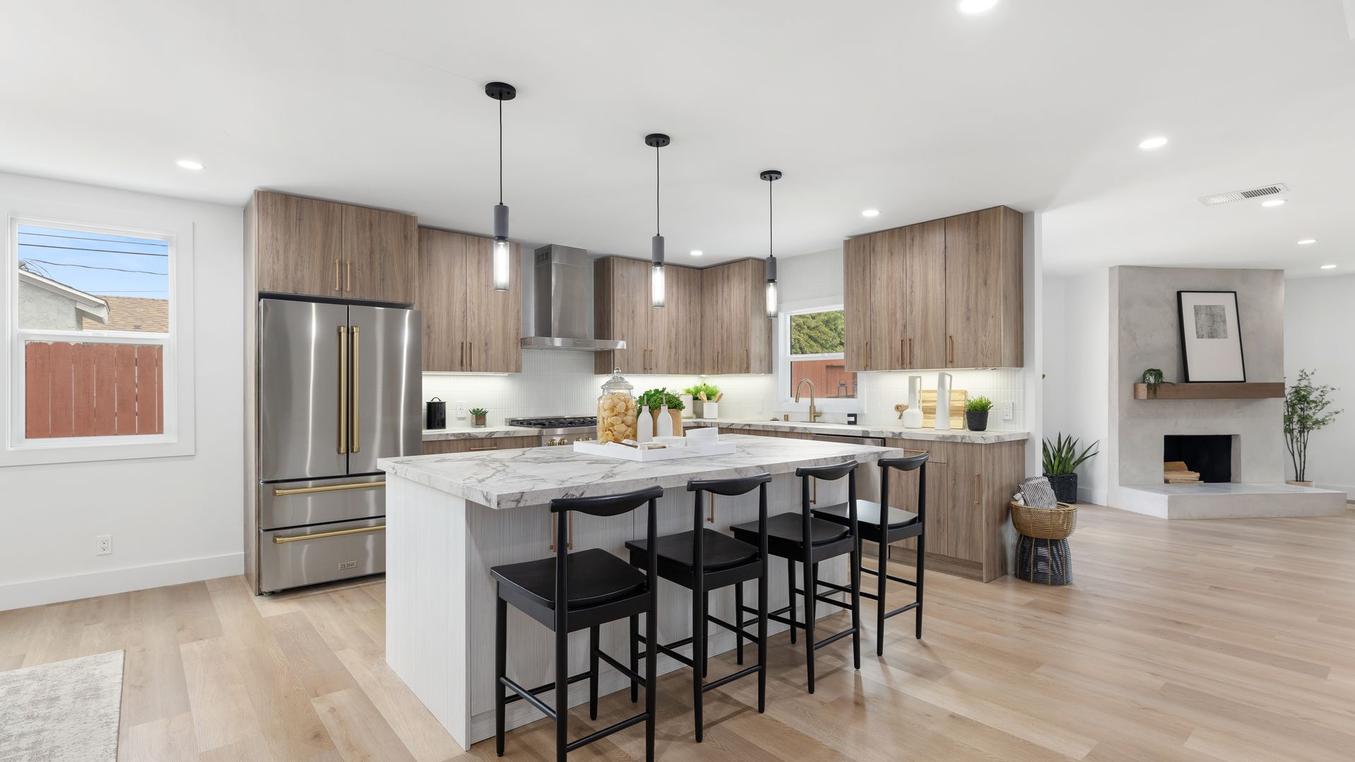 Bright modern kitchen remodel with island and barstools by Girl Flip Construction in Los Angeles